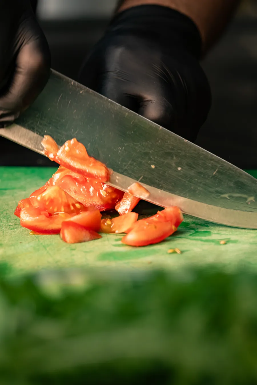 Fresh tomatoes being prepared in the Pizza Calzone kitchen